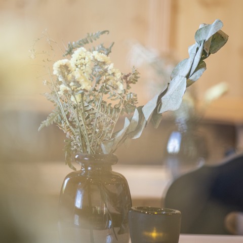 Das Bild zeigt ein paar Blumen auf einem Tisch.